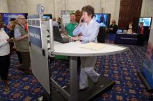 Ranking Member Susan M. Collins demonstrates some of the new technology being presented at the Committee's Healthy Aging Forum. 